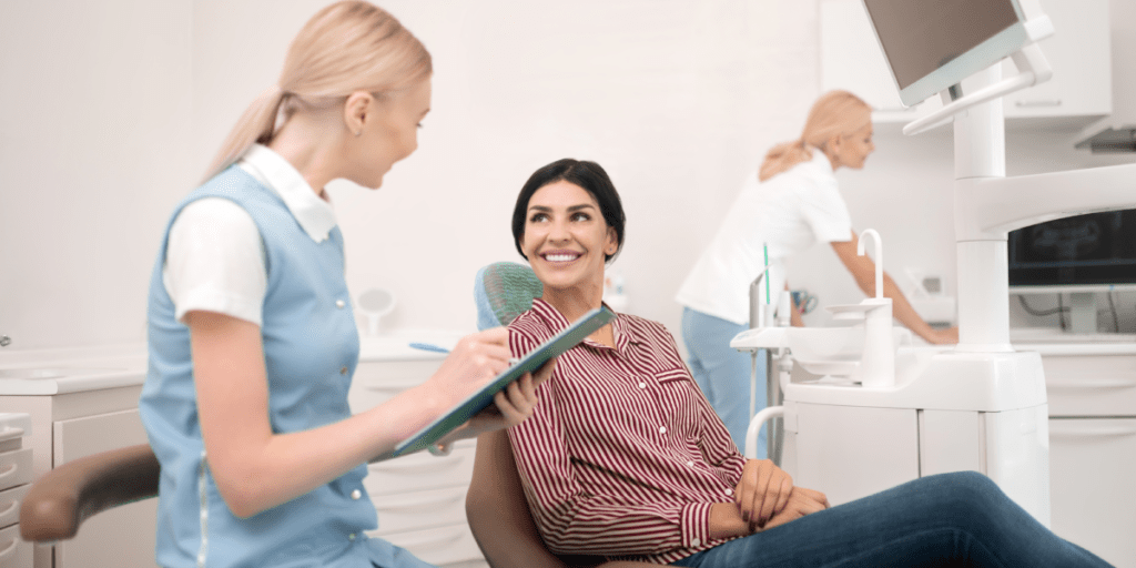 patient talking to dental assistant